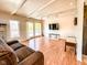 Bright living room with vaulted ceiling, fireplace, wood floors, and sliding doors leading to the deck at 12930 River Grove Dr, Columbus, IN 47203