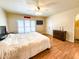Cozy main bedroom with white bedding, a ceiling fan, and a large window overlooking a deck at 12930 River Grove Dr, Columbus, IN 47203