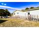 Fenced yard with mature trees and exterior view of the home at 12930 River Grove Dr, Columbus, IN 47203