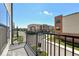Balcony with black railings overlooking a community street and neighboring townhomes at 12974 Pettigru Dr, Carmel, IN 46032