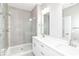 Modern bathroom boasts a glass shower, dual sinks, and elegant finishes offering a spa-like experience at 12974 Pettigru Dr, Carmel, IN 46032