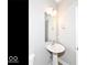 Bathroom featuring a pedestal sink, modern light fixture, and a toilet at 12974 Pettigru Dr, Carmel, IN 46032
