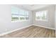 Bedroom with wood-look floors, neutral walls, and large windows for natural light at 12974 Pettigru Dr, Carmel, IN 46032