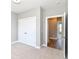Bedroom showing wardrobe doors and an open doorway to another room with wood flooring at 12974 Pettigru Dr, Carmel, IN 46032