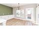 Stylish dining room featuring wood floors, modern light fixture, and lots of cabinets at 12974 Pettigru Dr, Carmel, IN 46032