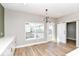 Bright dining area featuring wood floors, sliding barn door, and modern light fixture at 12974 Pettigru Dr, Carmel, IN 46032