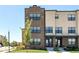 Modern brick and beige townhouse with black-trimmed windows under a clear blue sky at 12974 Pettigru Dr, Carmel, IN 46032