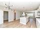 Open kitchen featuring a center island, wood floors, and stainless steel appliances at 12974 Pettigru Dr, Carmel, IN 46032