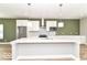Modern kitchen featuring a large island, stainless steel appliances, and white cabinets at 12974 Pettigru Dr, Carmel, IN 46032