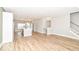 Open-concept floor plan with a modern kitchen, staircase, and wood flooring at 12974 Pettigru Dr, Carmel, IN 46032