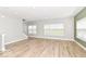 Open concept living room with wood-look floors and an abundance of natural light at 12974 Pettigru Dr, Carmel, IN 46032