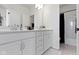 Bright bathroom featuring double vanity, neutral countertops, white cabinets, and patterned tile flooring at 13071 Pennington Rd, Fishers, IN 46037