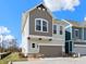 Two-story home featuring neutral paint, a covered porch, landscaping, an attached garage, and a cozy front yard at 13071 Pennington Rd, Fishers, IN 46037