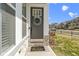Attractive front door adorned with a wreath and a welcoming doormat on a charming porch at 13071 Pennington Rd, Fishers, IN 46037