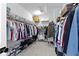 Walk-in closet providing ample storage with shelves, racks, and organized clothing at 13071 Pennington Rd, Fishers, IN 46037