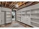 Spacious basement includes built-in shelving and visible ceiling beams at 140 E 44Th St, Indianapolis, IN 46205