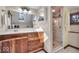 Bathroom featuring a dark wood vanity, large mirror, and glass enclosed shower at 140 E 44Th St, Indianapolis, IN 46205