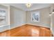 Bedroom with wood floors, two windows with built-in benches, and traditional lighting at 140 E 44Th St, Indianapolis, IN 46205