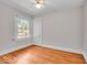 Bedroom with hardwood floors, a ceiling fan, and large window at 140 E 44Th St, Indianapolis, IN 46205