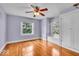 Bedroom featuring light-purple walls, hardwood floors, and two windows at 140 E 44Th St, Indianapolis, IN 46205