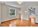 Bright bedroom with hardwood floors, a large window, and an open doorway to another room at 140 E 44Th St, Indianapolis, IN 46205