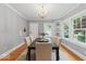 Elegant dining room features a modern chandelier, ample windows, and seating for six at 140 E 44Th St, Indianapolis, IN 46205