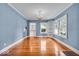 Dining room features hardwood floors, ample natural light, classic chandelier, and doorway to kitchen at 140 E 44Th St, Indianapolis, IN 46205