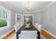 Charming dining room with chandelier, natural light, and classic details creates a welcoming atmosphere at 140 E 44Th St, Indianapolis, IN 46205