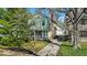 Charming two-story home with a gambrel roof, inviting front porch with swing, and brick chimney at 140 E 44Th St, Indianapolis, IN 46205