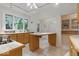 Bright kitchen featuring a breakfast bar, tile flooring, and stainless steel appliances near the window at 140 E 44Th St, Indianapolis, IN 46205