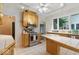 Well-lit kitchen with stainless steel appliances, tile countertops, and access to adjacent rooms at 140 E 44Th St, Indianapolis, IN 46205