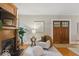Living room with a fireplace, wooden mantel, hardwood floors, and neutral color palette at 140 E 44Th St, Indianapolis, IN 46205