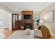 Cozy living room showcasing a fireplace, built-in shelving, and warm wood trim at 140 E 44Th St, Indianapolis, IN 46205