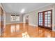 Bright living room boasts gleaming hardwood floors, elegant french doors, and sun-drenched windows at 140 E 44Th St, Indianapolis, IN 46205
