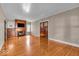 Bright living room boasts gleaming hardwood floors, fireplace, and elegant french doors to other rooms at 140 E 44Th St, Indianapolis, IN 46205