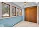 Cozy sunroom with multiple windows, shiplap walls, and a wooden closet at 140 E 44Th St, Indianapolis, IN 46205
