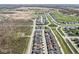 Aerial view shows the residential neighborhood layout, community spaces, surrounding woods, and location near farmland at 14234 Community Dr, Carmel, IN 46033