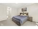 Comfortable bedroom with neutral tones, carpet flooring, and a large bed with drawer storage at 14234 Community Dr, Carmel, IN 46033