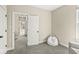 Bedroom features neutral walls, gray carpet, and doorway leading to another room at 14234 Community Dr, Carmel, IN 46033