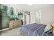 Bedroom with a nature-themed accent wall, neutral carpet, and a large dresser with drawers at 14234 Community Dr, Carmel, IN 46033