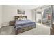 Cozy bedroom with a platform bed, bedside tables, and a sliding glass door to a patio at 14234 Community Dr, Carmel, IN 46033