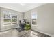 Well-lit bedroom with large windows offering street views, perfect for a home office setup at 14234 Community Dr, Carmel, IN 46033