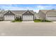 These homes feature attached two-car garages, manicured lawns, and similar architectural style for a cohesive neighborhood at 14234 Community Dr, Carmel, IN 46033
