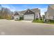 The homes feature attached two-car garages, manicured lawns, and similar architecture for a uniform neighborhood aesthetic at 14234 Community Dr, Carmel, IN 46033