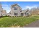 Charming two-story home boasts great curb appeal with its manicured lawn and inviting front porch at 14234 Community Dr, Carmel, IN 46033