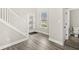 Bright foyer showcasing hardwood floors, staircase, and a convenient half-bathroom at 14234 Community Dr, Carmel, IN 46033