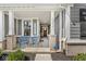 Inviting front porch with seating area, perfect for relaxing and enjoying the neighborhood views at 14234 Community Dr, Carmel, IN 46033