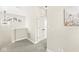 Hallway with gray carpet, white trim, and modern lighting fixture leading to bedrooms at 14234 Community Dr, Carmel, IN 46033