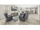 Bright open-concept living room with gray recliners, stylish rug, and TV at 14234 Community Dr, Carmel, IN 46033