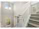 Bright and airy staircase with white railings and carpeted steps, illuminated by natural light at 14234 Community Dr, Carmel, IN 46033